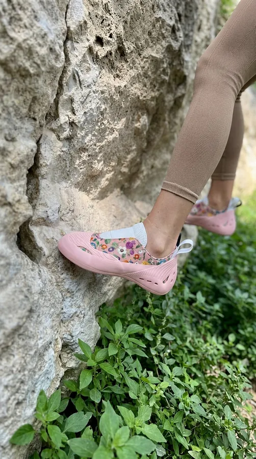 Pink climbing shoe on a limestone hold