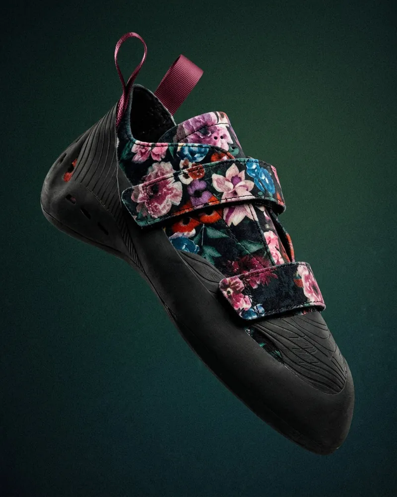 Dual-velcro dark floral climbing shoe on a green backdrop