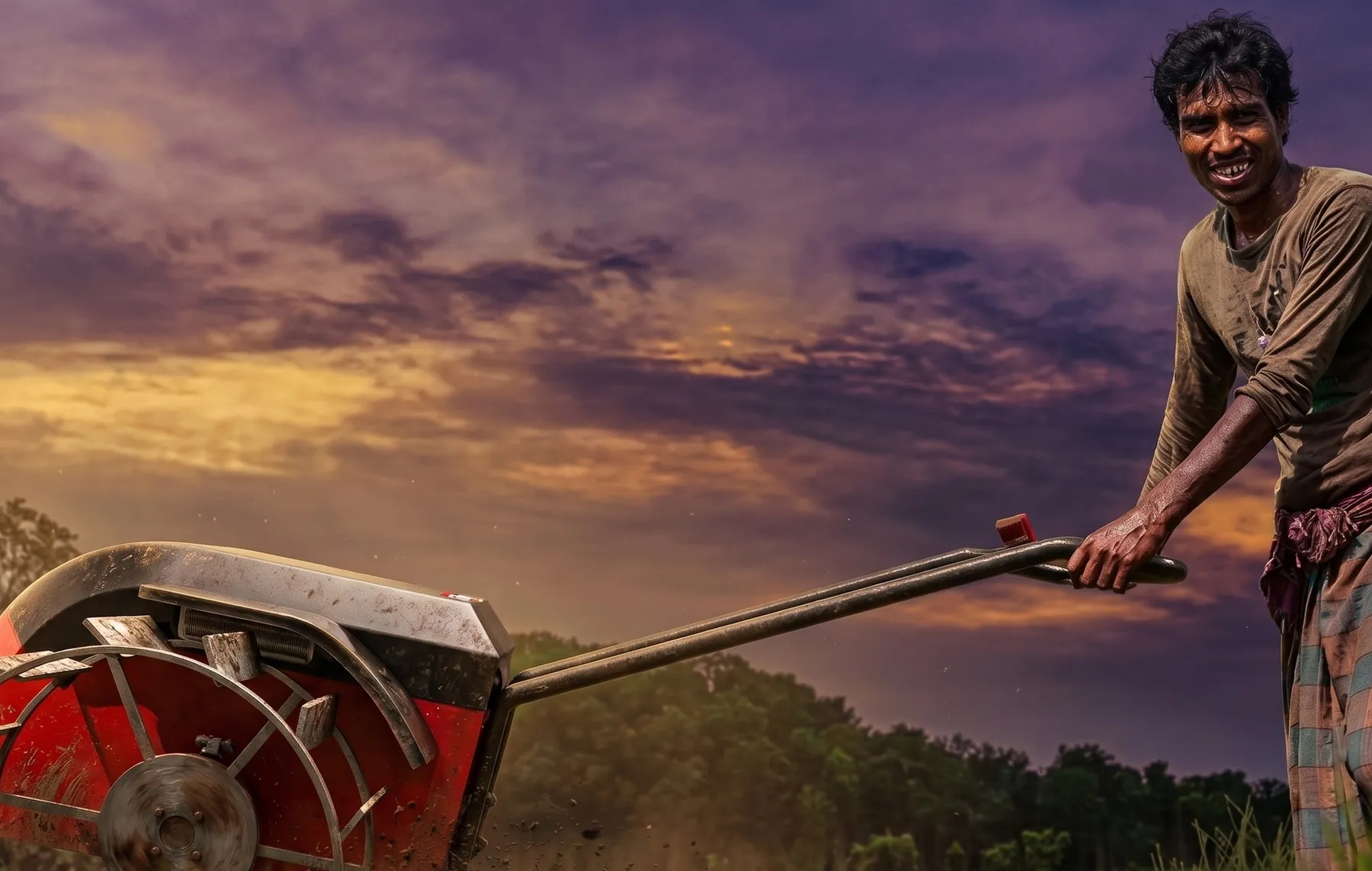 Farmer steering the red E-kuliglig hand tractor through a field at sunset