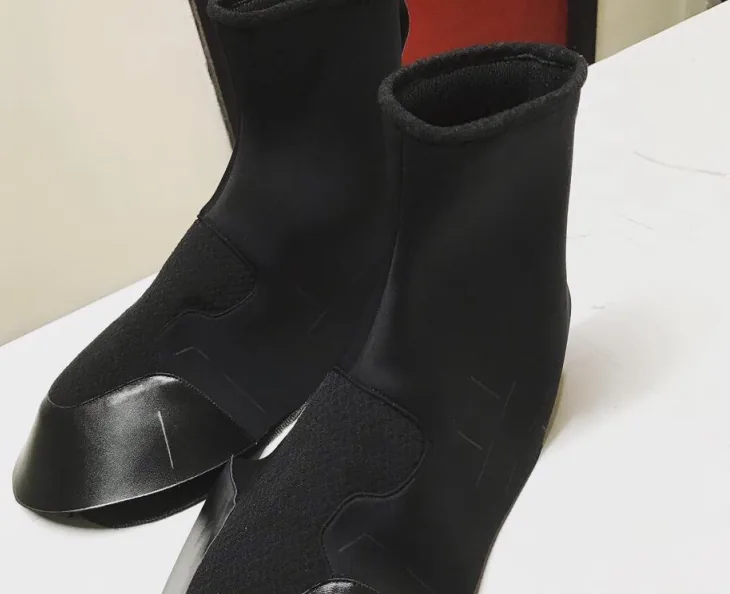 Black neoprene sock upper on a last at the workshop