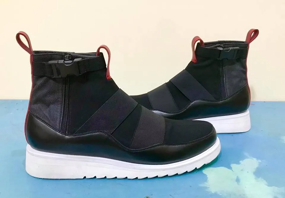 Second prototype pair with red pull loops on a chunky white sole