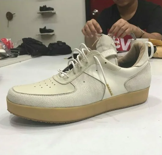 First PAMBA prototype in cream on a gum sole, being laced at the workshop