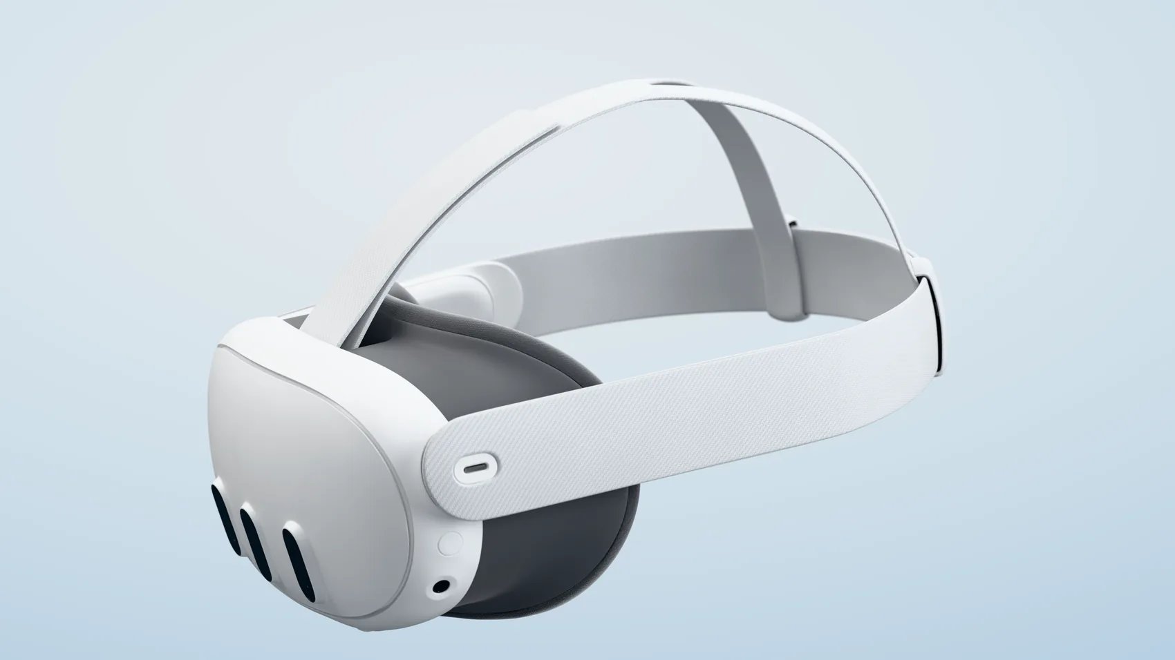 Meta Quest 3 headset at a three-quarter angle on a pale blue backdrop